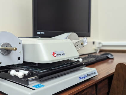 Photo of microfilm reader and computer