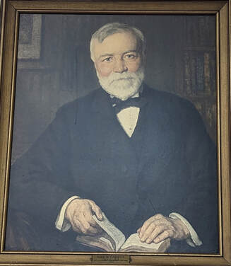 A portrait of Andrew Carnegie housed in the Syracuse Public Library.