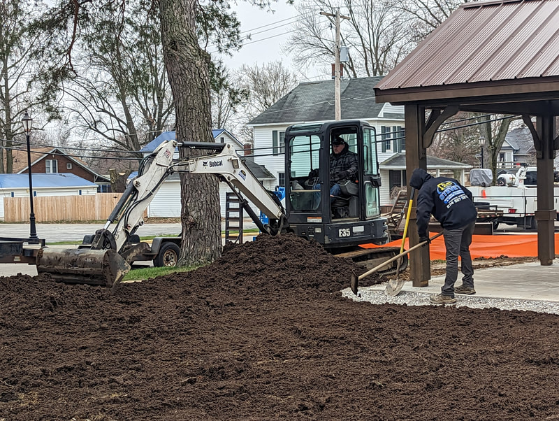 Contractors add dirt to level out the property.