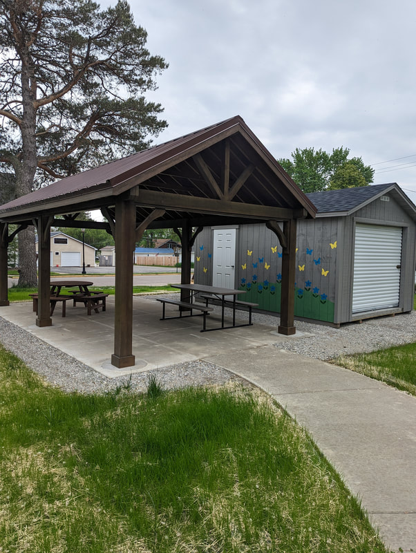 Community Roots' structures: a pavilion, picnic tables and a storage barn.